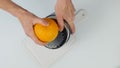 Confectioner cuts the orange peel, citrus zester grating peeling orange peel. 4K top view