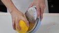 Confectioner cuts the orange peel, citrus zester grating peeling orange peel