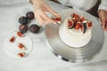 Confectioner decorates bento cake with figs