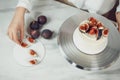 Confectioner decorates bento cake with figs