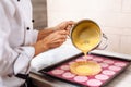 The confectioner fills the lemon pie with stuffing.