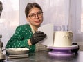 Confectioner girl makes a cake