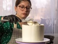 Confectioner girl makes a cake