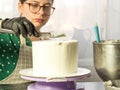 Confectioner girl makes a cake