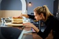 The confectioner girl puts the cakes for the cake.