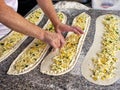 confectioner making turkish cake with cheese, greens, corn
