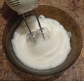 Confectioner mixing bizet for cake in bowl