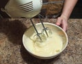 Confectioner mixing cream for cake with mixer