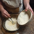 Confectioner mixing flour with cake ingredients