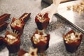 Confectioner pastry woman preparing eclairs and cupcakes Royalty Free Stock Photo