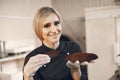 Confectioner pastry woman preparing eclairs and cupcakes Royalty Free Stock Photo