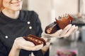 Confectioner pastry woman preparing eclairs and cupcakes Royalty Free Stock Photo