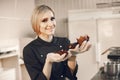 Confectioner pastry woman preparing eclairs and cupcakes Royalty Free Stock Photo