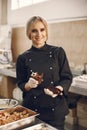 Confectioner pastry woman preparing eclairs and cupcakes Royalty Free Stock Photo