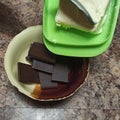 Confectioner pour butter to bowl with chocolate