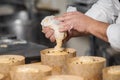 Confectioner topping panettone cakes with piping bag glazed sweet filling