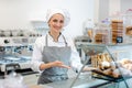 Confectioner woman in her shop selling cookies and cakes