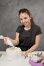 Confectioner at work. Cream cake decorating. Cook table preparing a cake. Royalty Free Stock Photo