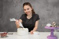 Confectioner at work. Cream cake decorating. Cook table preparing a cake. Royalty Free Stock Photo