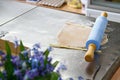 Confectioner works with dough on a table in a pastry shop, cuts out forms