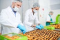 Confectioners making pastry with chocolate cream