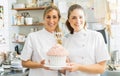 confectioners smiling proudly and holding big Birthday cake muffin with candies at pastry bakery