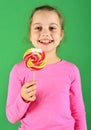 Confectionery and childhood concept. Lady holds round lollipop.
