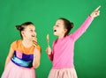 Confectionery and childhood concept. Sisters with round and long lollipops.