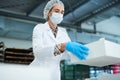 Confectionery factory worker holding paper box