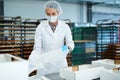 Confectionery factory worker preparing empty boxes