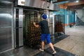 Confectionery manufacturing. Baker puts cookies into oven for baking