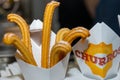 Confectionery product Churros with powdered sugar in a carton