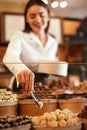 Confectionery. Woman Selling Chocolate Candies In Store