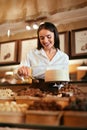 Confectionery. Woman Selling Chocolate Candies In Store