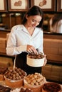 Confectionery. Woman Selling Chocolate Candies In Store Royalty Free Stock Photo