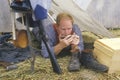 Confederate participant in camp scene playing mouth harp during recreation of Battle of Manassas, marking the beginning of the