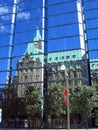 Confederation Building on Parliament Hill reflected in Glass Fascade of Bank of Canada Building, Ottawa, Ontario, Canada Royalty Free Stock Photo