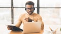 Concentrated african american guy in headset writing notes Royalty Free Stock Photo