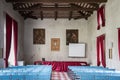 Conference hall in ancient villa with canvas blue chairs and red curtains