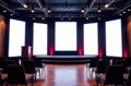 The conference hall has a modern stage, large screens, and arranged seating for the upcoming presentation Royalty Free Stock Photo