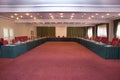 Conference hall at the hotel. Red tables and red carpet . Elegant and rich designed banquet hall. Great file for your new catering Royalty Free Stock Photo