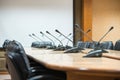 Before a conference, the microphones in front of empty chairs. Royalty Free Stock Photo