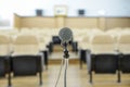 Before a conference, the microphones in front of empty chairs.