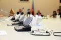 Before a conference, the microphones in front of empty chairs . Soft focus of wireless Conference microphones in a meeting room. M