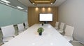 Conference room in a modern office building. Marble table, chair and large presentation monitor with blank screen prepare for a Royalty Free Stock Photo