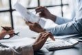 A conference room where executives and marketers are looking at sales documents to analyze, plan marketing and do sales promotions Royalty Free Stock Photo