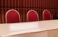 Conference table with red chairs and triangle board in meeting room Royalty Free Stock Photo