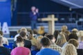 Conferences Concepts. Male Lecturer Speaking On Stage In front of the Large Group of People. Royalty Free Stock Photo