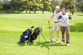 Conferring over the best shot to take. Golfing companions out on the course playing a round of golf.