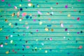 Confetti falling on wooden background